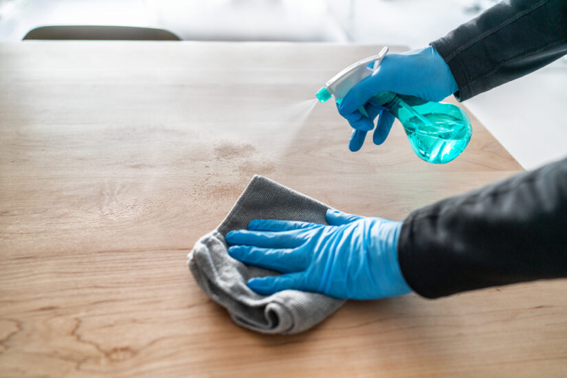 Photo of a Man Cleaning a Table