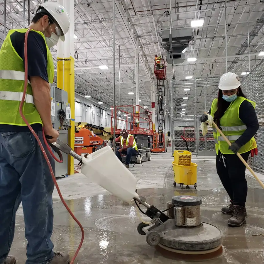 Miami Top Cleaning technician polishing a concrete floor with a rotary machine
